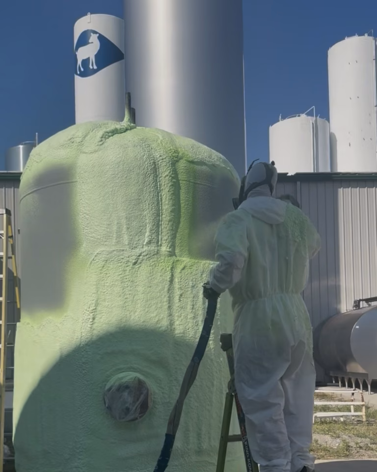 Technician installing spray foam insulation