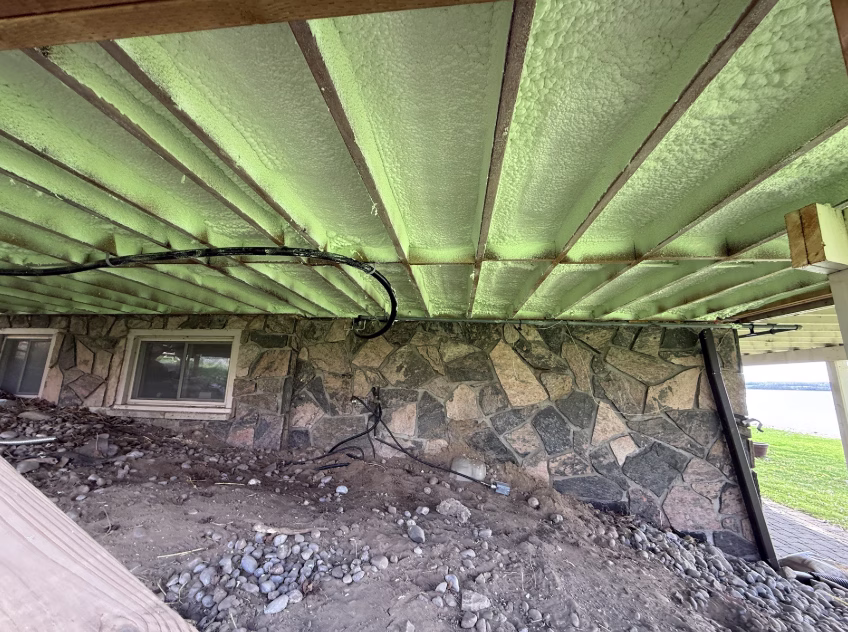 Spray foam insulation applied to flooring of a Peterborough home.